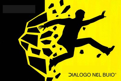Facebook add for dialogue nel buio showing a yellow and black sketch of a man breaking through a wall.