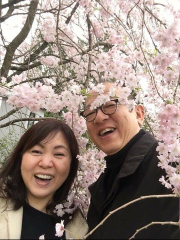 Portrait of Shinsuke and Kiyoe standing in the middle of cherry blossoms.